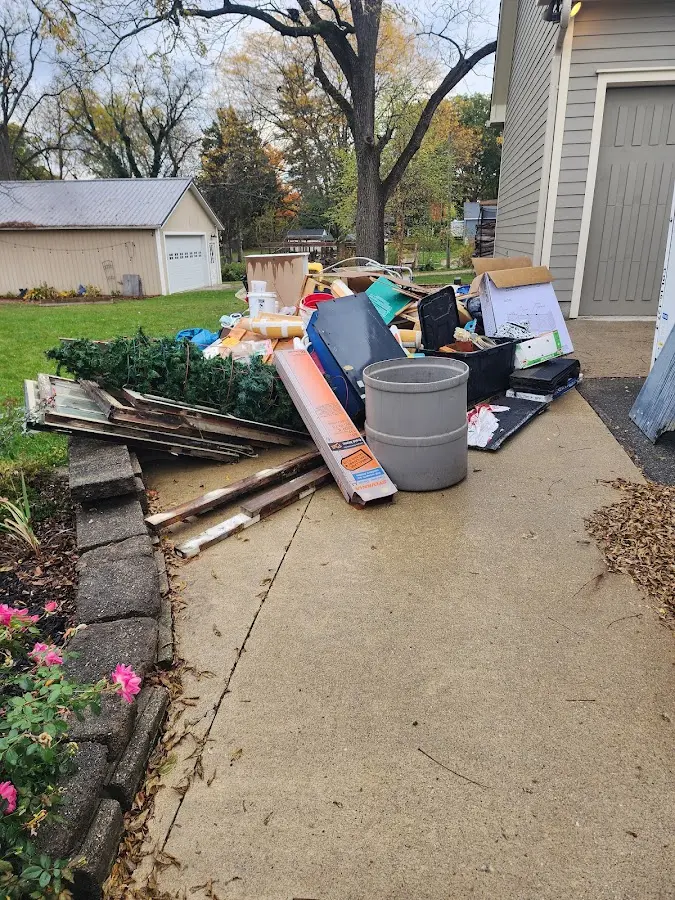 Dumpster being loaded with debris for Commercial Dumpster Rental in Lake Monticello